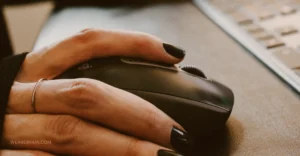 Hand on the computer mouse close up